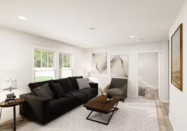 Modern living room with black sofa, gray armchair, wooden coffee table, and abstract wall art.