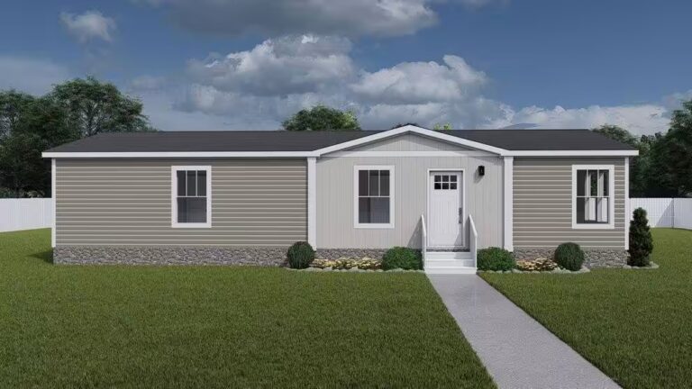 Single-story tan manufactured home with white trim, gray roof, and concrete walkway on green lawn.