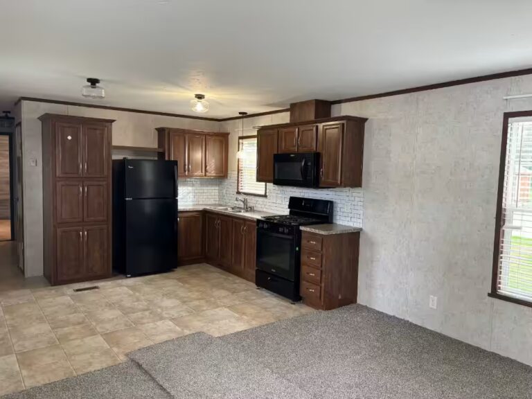Kitchen with brown cabinets, black appliances, white tile backsplash, and beige tiled floor.